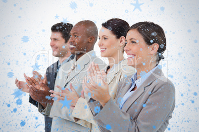Side view of clapping sales team standing together
