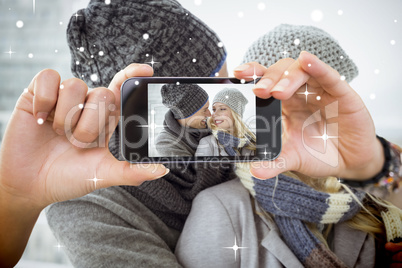 Hand holding smartphone showing photo