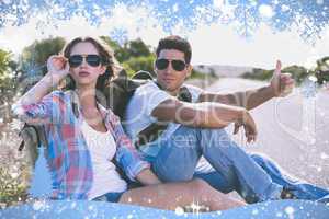 Couple hitchhiking on countryside road