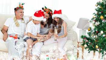 Composite image of family on christmas day looking at their pres