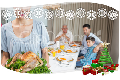 Woman holding chicken roast with family at dining table