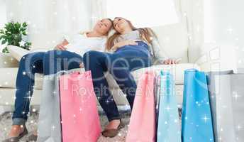 Composite image of a couple of girls sitting after a hard day of