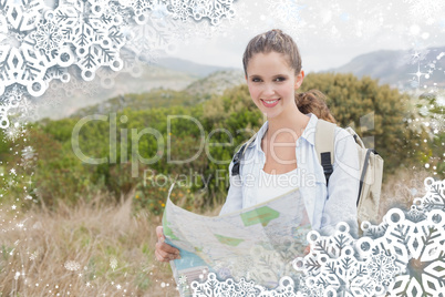 Portrait of a hiking young woman holding map