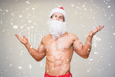 Portrait of shirtless macho man with fake santa beard