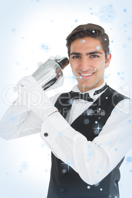 Attractive young barkeeper shaking a drink