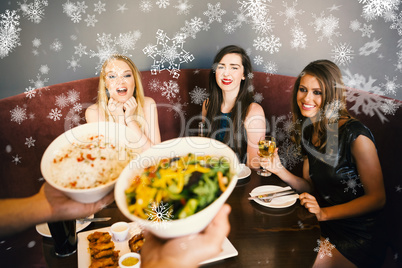 Composite image of happy friends looking at the salad
