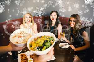 Composite image of happy friends looking at the salad