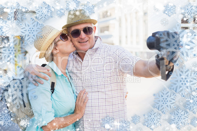 Happy tourist couple taking a selfie in the city