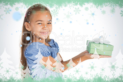 Cheerful little girl giving a present