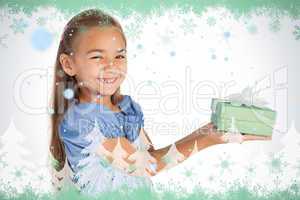 Cheerful little girl giving a present