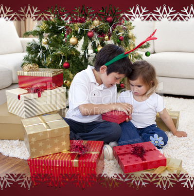 Happy brother and sister opening christmas gifts