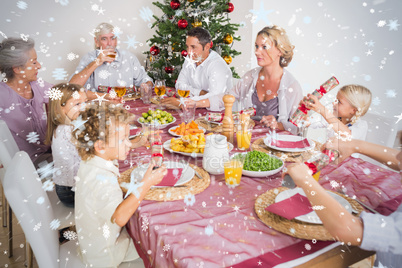 Composite image of family having christmas dinner