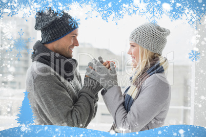 Cute couple in warm clothing smiling at each other