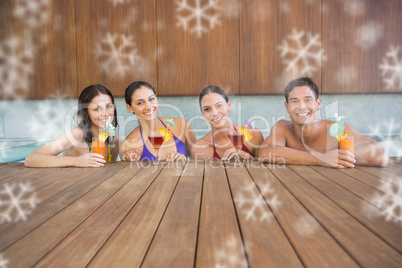 Cheerful people with drinks in swimming pool