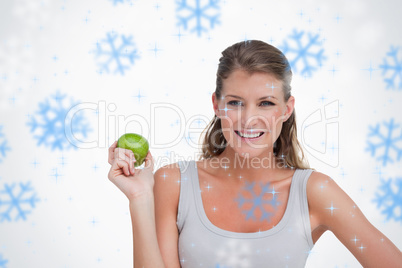 Composite image of woman holding an apple