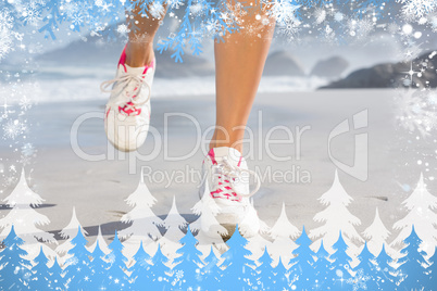 Composite image of fit woman walking on the beach