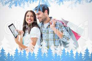 Composite image of attractive young couple with shopping bags an