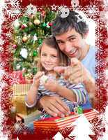 Father and little girl playing with christmas presents