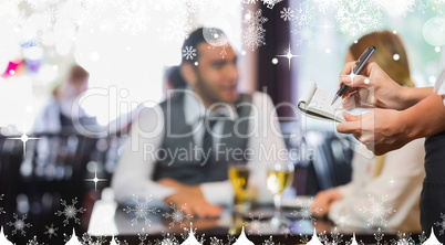 Composite image of waitress writing an order