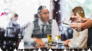 Composite image of waitress writing an order