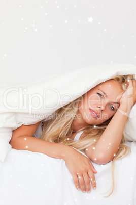 Composite image of portrait of a woman waking up
