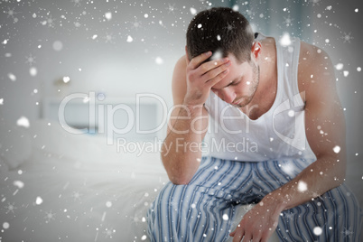 Composite image of ill man sitting on his bed