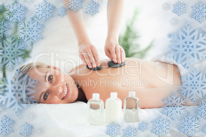 Close up of a blonde woman experiencing a stone therapy