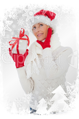 Festive woman listening and holding gift