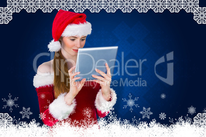 Composite image of pretty santa girl using tablet pc