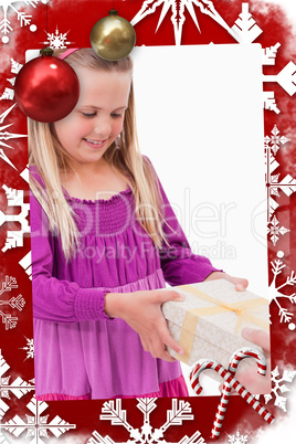 Composite image of portrait of a girl receiving a present