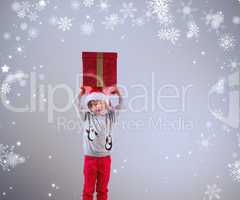 Composite image of cute festive boy with present