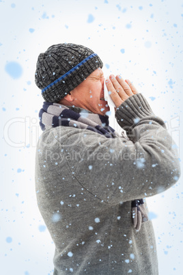 Sick mature man blowing his nose