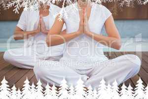 Couple in white sitting in lotus pose with hands together