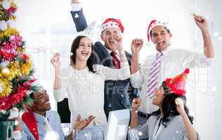 Business team punching the air to celebrate christmas