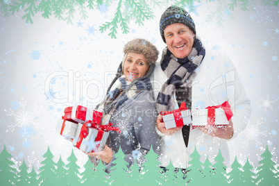 Mature couple in winter clothes holding gifts