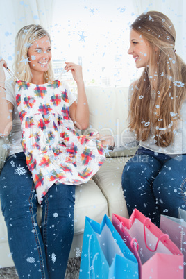 Composite image of girls looking at each other as they try out new clothes