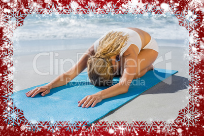 Gorgeous fit blonde in childs pose on the beach