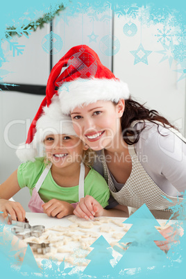 Beautiful mother and daughter cooking christmas biscuits