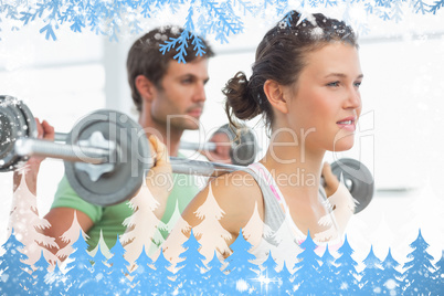 Fit young couple lifting barbells