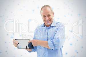 Happy mature man pointing to his tablet pc