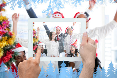 Composite image of hand holding tablet pc