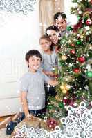 Happy family decorating a christmas tree with boubles and presen