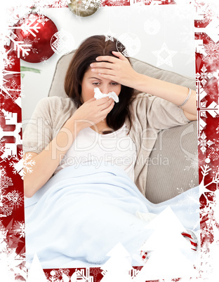 Tired woman feeling her temperature while blowing her nose