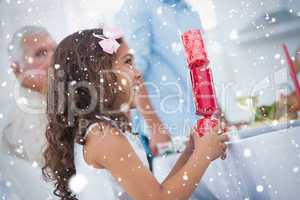 Composite image of cute little girl holding crackers