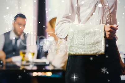 Waitress standing in front of two business people talking