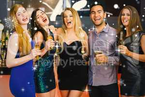 Composite image of laughing friends holding beers posing