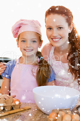 Mother and daughter with ingredients for cookies