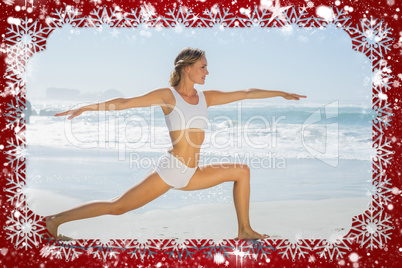 Gorgeous blonde in warrior pose by the sea