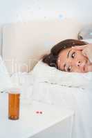 Cute woman lying under sheet having headache