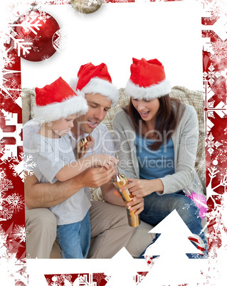 Happy parents with son opening crackers together